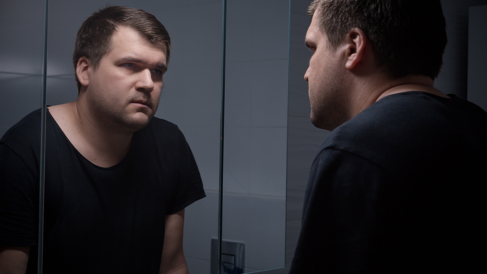 Person staring in mirror with self-doubt captions