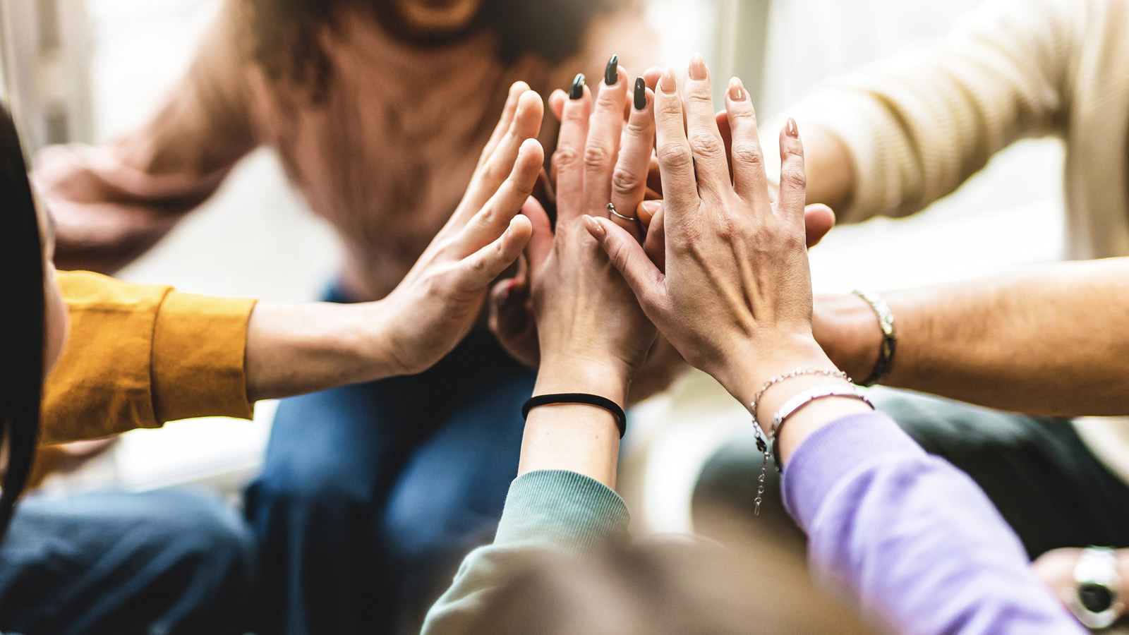 A joyful moment of women stacking hands in a cirlce