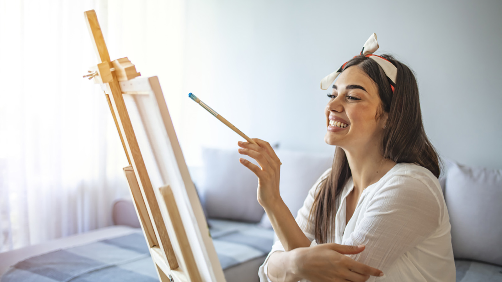 Person painting and smiling, finding joy in their passion